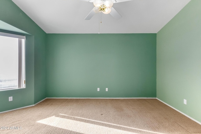 carpeted empty room featuring ceiling fan