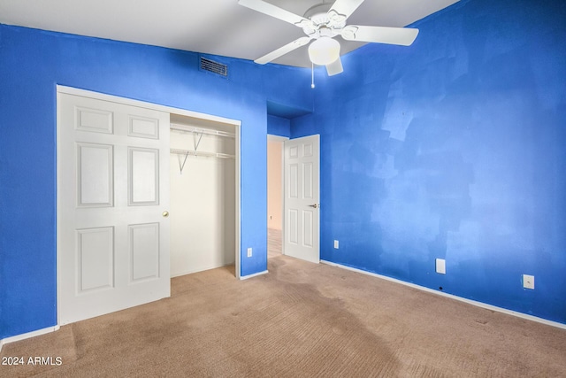 unfurnished bedroom with ceiling fan, a closet, and carpet flooring