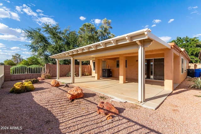 back of house featuring cooling unit and a patio