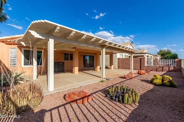 rear view of house with central AC unit, a pergola, and a patio area