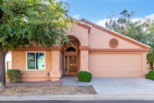 mediterranean / spanish house with a garage