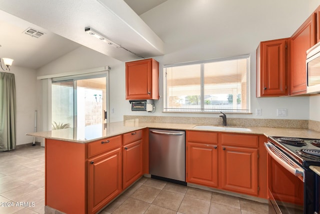 kitchen featuring appliances with stainless steel finishes, sink, kitchen peninsula, vaulted ceiling, and light tile patterned floors