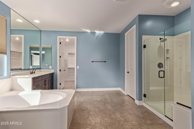 bathroom featuring vanity and independent shower and bath