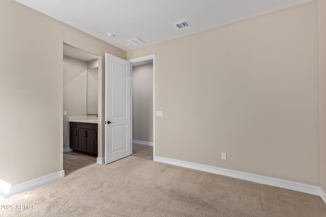 unfurnished bedroom featuring light carpet