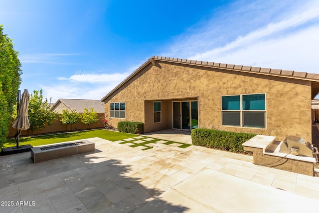 rear view of house featuring a patio