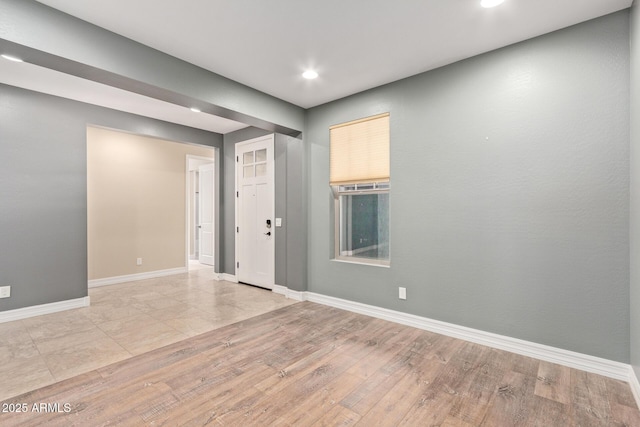 empty room with light hardwood / wood-style flooring