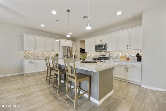 kitchen with white cabinetry and appliances with stainless steel finishes