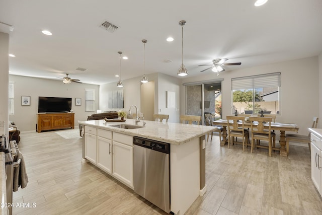 kitchen featuring pendant lighting, sink, stainless steel dishwasher, an island with sink, and white cabinetry