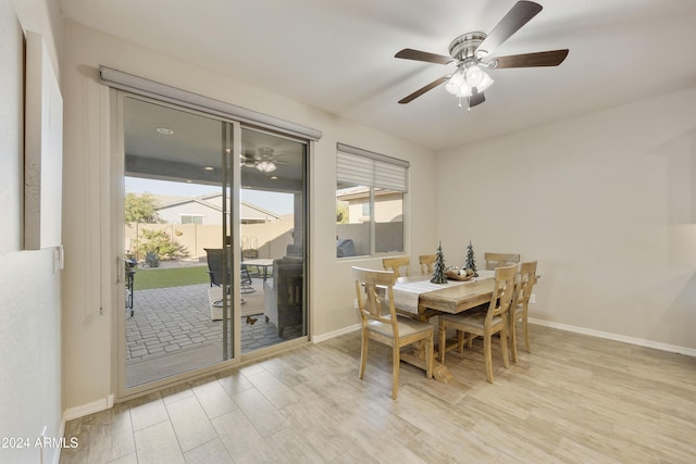 dining room with light hardwood / wood-style flooring and ceiling fan