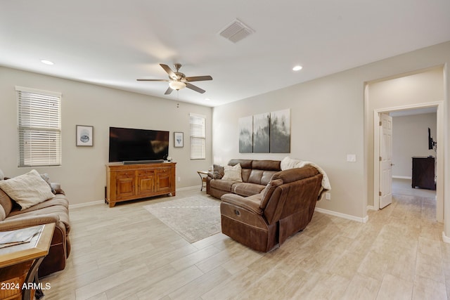 living room with ceiling fan and light hardwood / wood-style floors