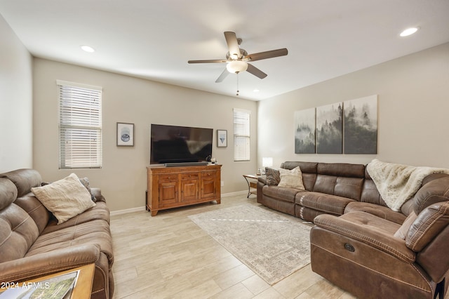 living room featuring ceiling fan and light hardwood / wood-style flooring