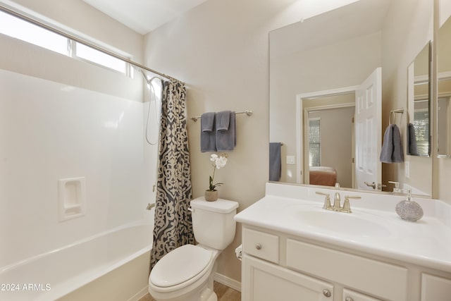 full bathroom with vanity, shower / bath combination with curtain, and toilet