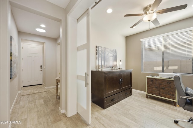 home office featuring light hardwood / wood-style flooring and ceiling fan