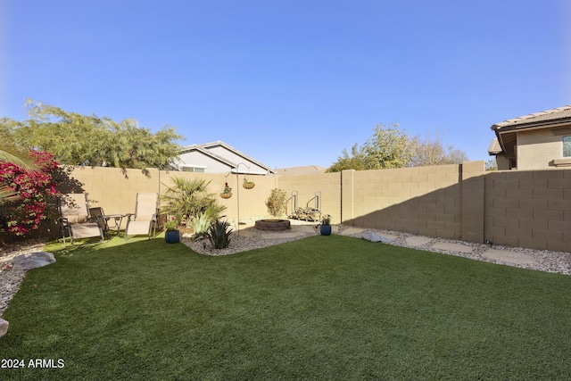 view of yard with a fire pit