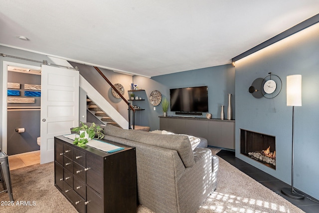 tiled living room featuring a barn door