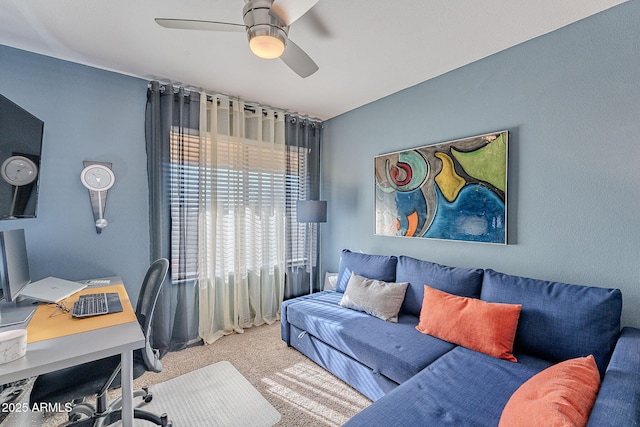 carpeted home office featuring ceiling fan