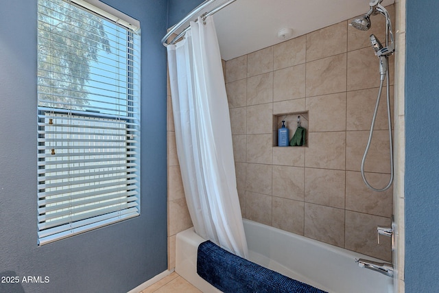 bathroom with a healthy amount of sunlight and shower / bathtub combination with curtain