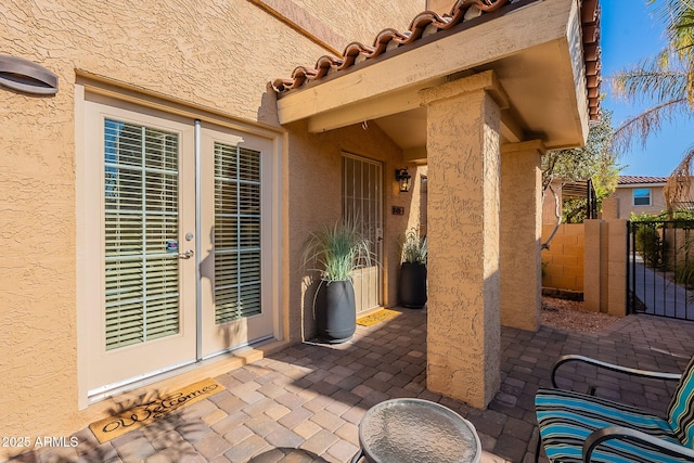 view of exterior entry featuring a patio area