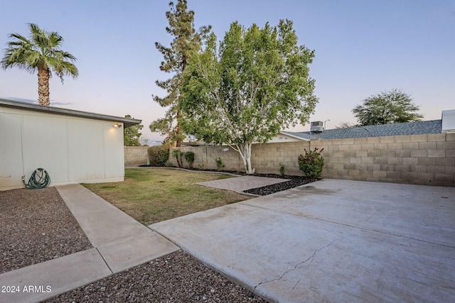 yard at dusk with a patio