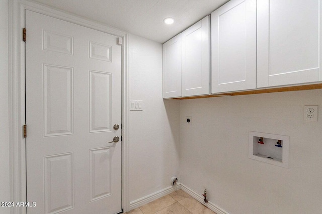 clothes washing area featuring cabinets, washer hookup, hookup for an electric dryer, gas dryer hookup, and light tile patterned floors