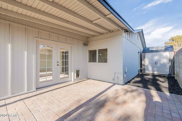 view of patio / terrace with french doors and a storage shed