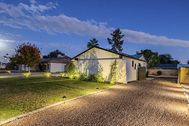 view of side of property with a yard