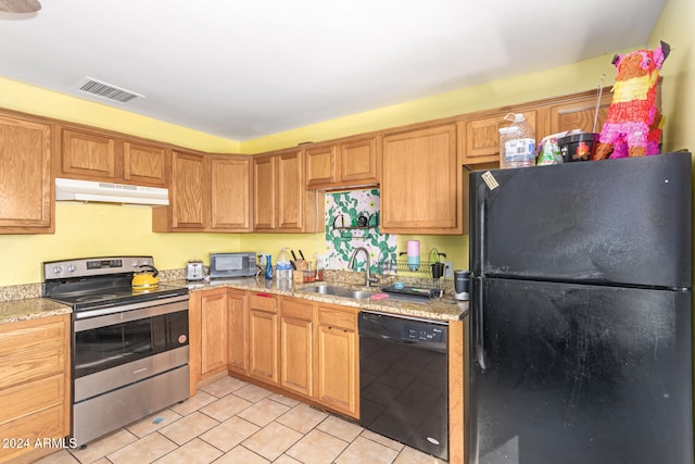 kitchen with light stone countertops, sink, and black appliances