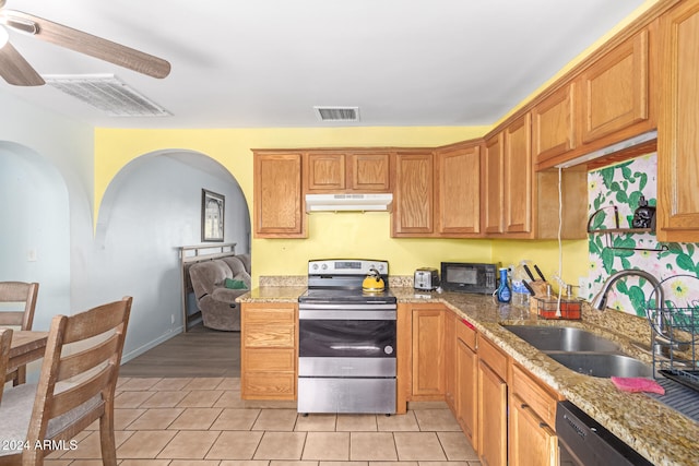 kitchen with sink, light hardwood / wood-style flooring, ceiling fan, light stone countertops, and appliances with stainless steel finishes