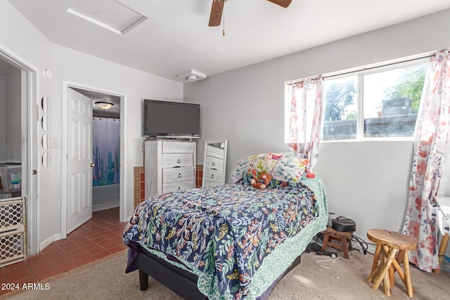 tiled bedroom featuring ceiling fan and ensuite bathroom