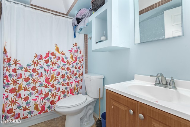 bathroom with tile patterned flooring, vanity, and toilet