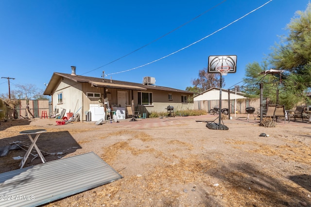 rear view of property featuring central AC unit