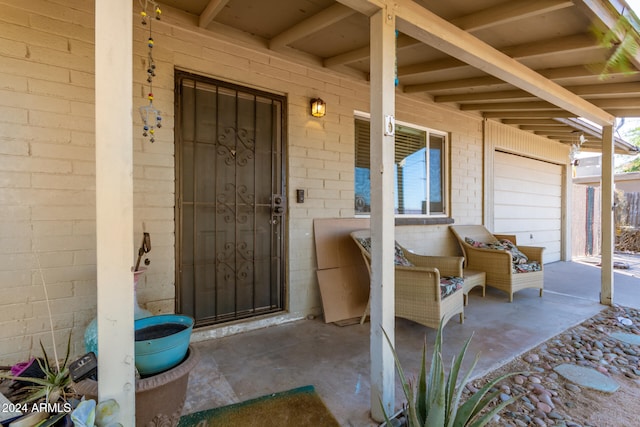 doorway to property featuring a porch and a garage