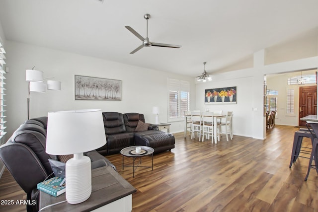 living room with dark hardwood / wood-style flooring, lofted ceiling, and ceiling fan