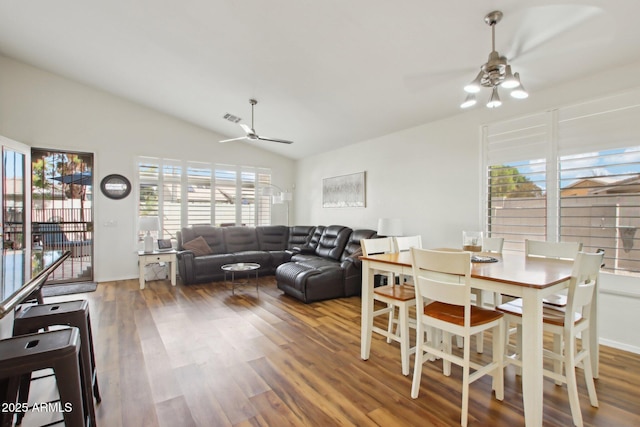 dining room with vaulted ceiling, hardwood / wood-style floors, and ceiling fan