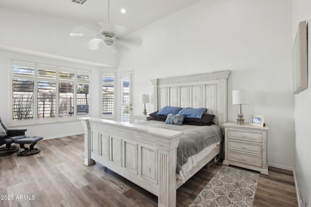 bedroom with dark hardwood / wood-style flooring, lofted ceiling, and ceiling fan