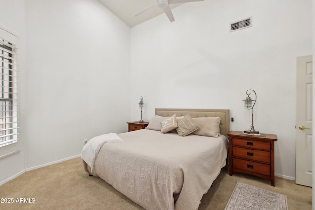 carpeted bedroom featuring ceiling fan and vaulted ceiling