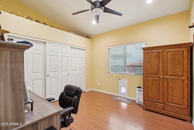 home office featuring lofted ceiling, ceiling fan, and light wood-type flooring