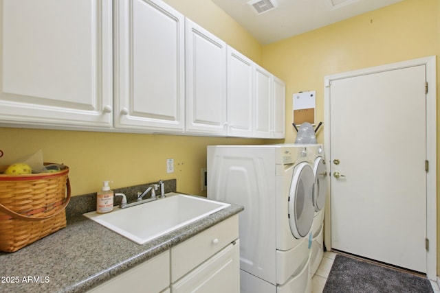 clothes washing area with cabinets, light tile patterned flooring, sink, and independent washer and dryer