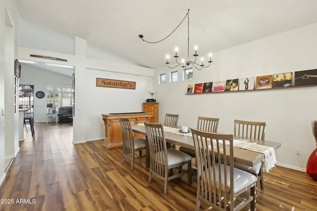 dining room featuring an inviting chandelier, lofted ceiling, and dark hardwood / wood-style floors