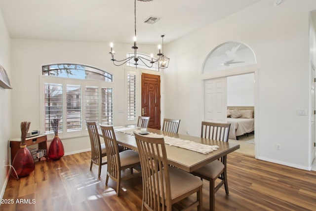 dining area featuring an inviting chandelier and dark hardwood / wood-style flooring