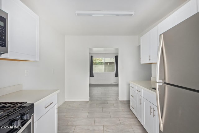 kitchen featuring white cabinetry and appliances with stainless steel finishes