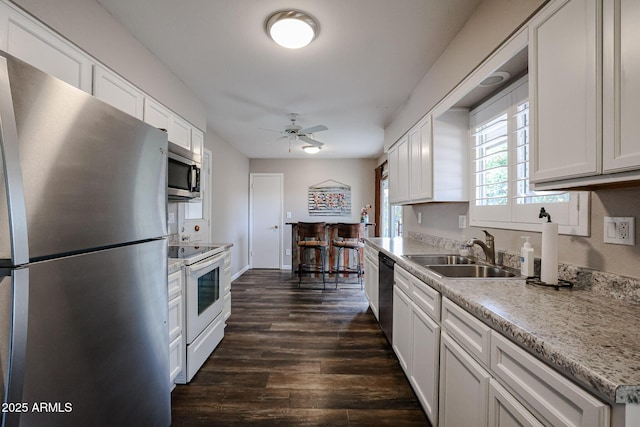 kitchen with sink, white cabinets, and appliances with stainless steel finishes