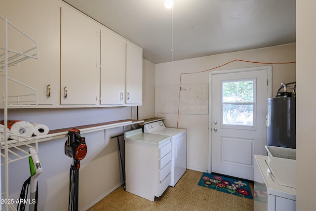 laundry area featuring washer and dryer, cabinets, and water heater