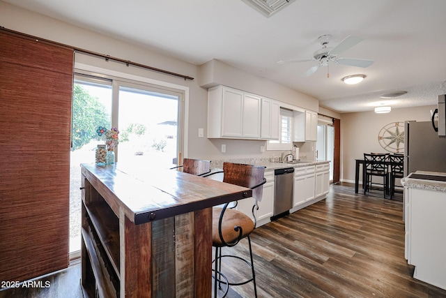 kitchen featuring dishwasher, dark hardwood / wood-style flooring, white cabinetry, and ceiling fan