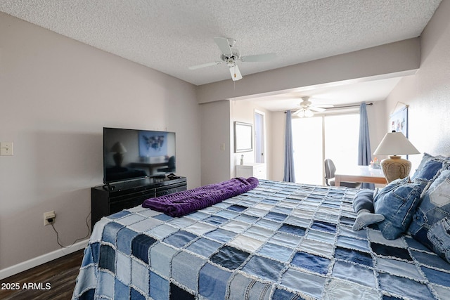 bedroom with ceiling fan, wood-type flooring, and a textured ceiling