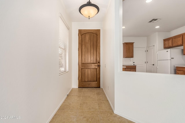 corridor with light tile patterned flooring