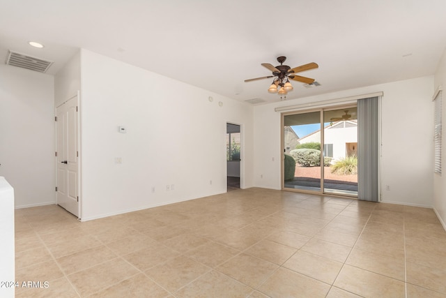 tiled spare room with ceiling fan