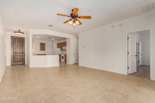 unfurnished living room with ceiling fan and light tile patterned floors