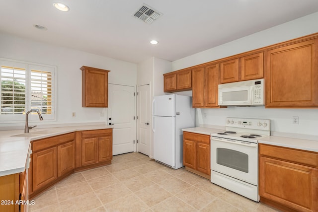 kitchen featuring white appliances and sink