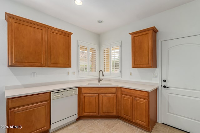 kitchen with sink, light tile patterned floors, and dishwasher